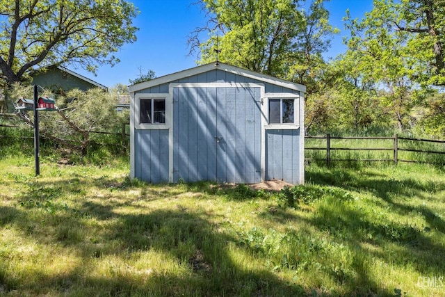 view of shed with fence