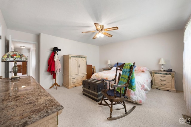 bedroom with light colored carpet and a ceiling fan