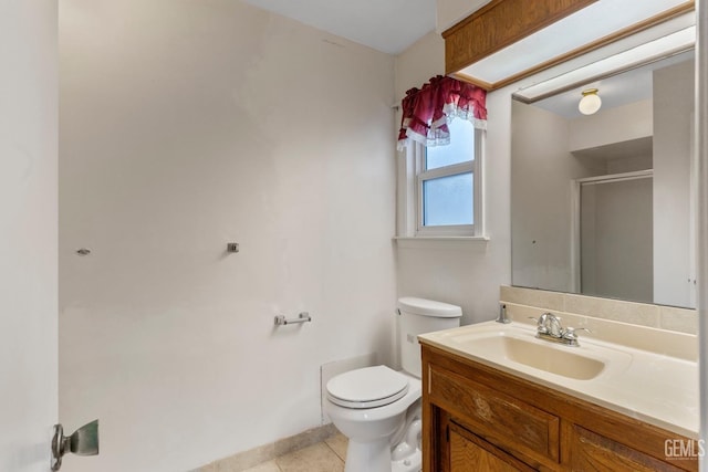 bathroom featuring tile patterned flooring, a shower with shower door, vanity, and toilet