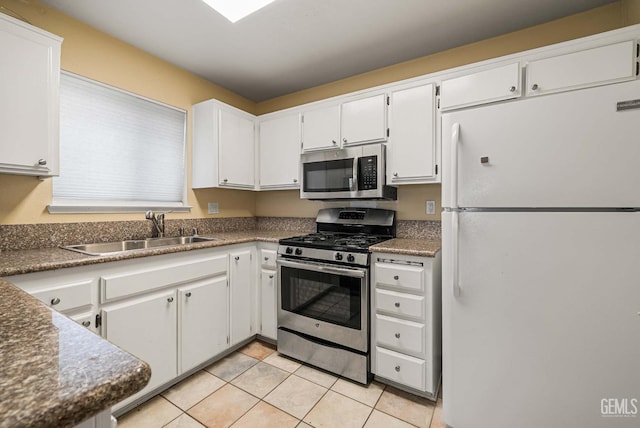 3717 Cypress Glen Blvd, Bakersfield, CA 93309 - kitchen with appliances with stainless steel finishes, a sink, white cabinets, and light tile patterned flooring