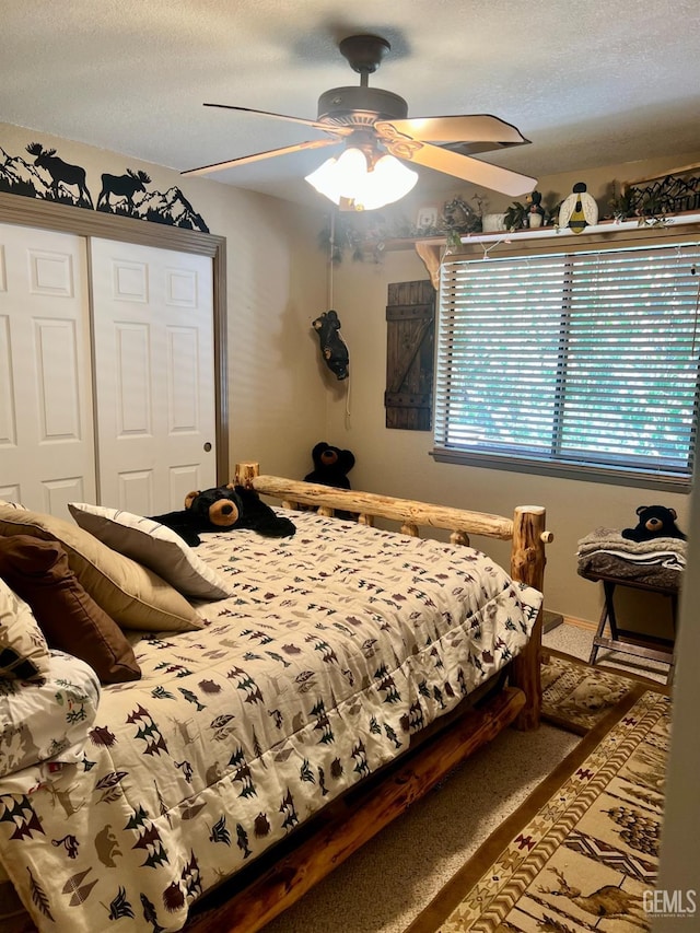 bedroom featuring a textured ceiling, a closet, and ceiling fan