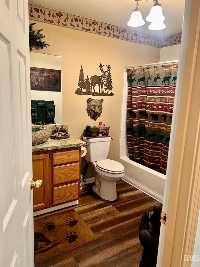 full bathroom with shower / bath combination with curtain, vanity, wood-type flooring, and toilet