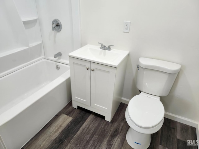 full bathroom featuring toilet, wood finished floors, vanity, baseboards, and shower / washtub combination