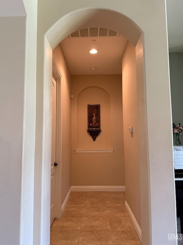2410 Exton St, Bakersfield, CA 93311 - corridor featuring arched walkways, light tile patterned floors, and recessed lighting