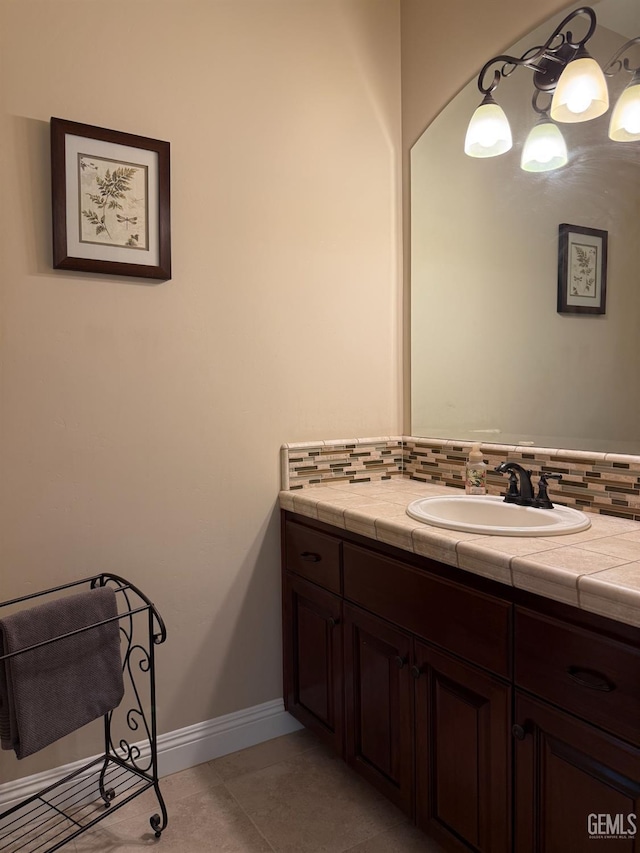 2410 Exton St, Bakersfield, CA 93311 - bathroom with vanity, tasteful backsplash, and tile patterned flooring