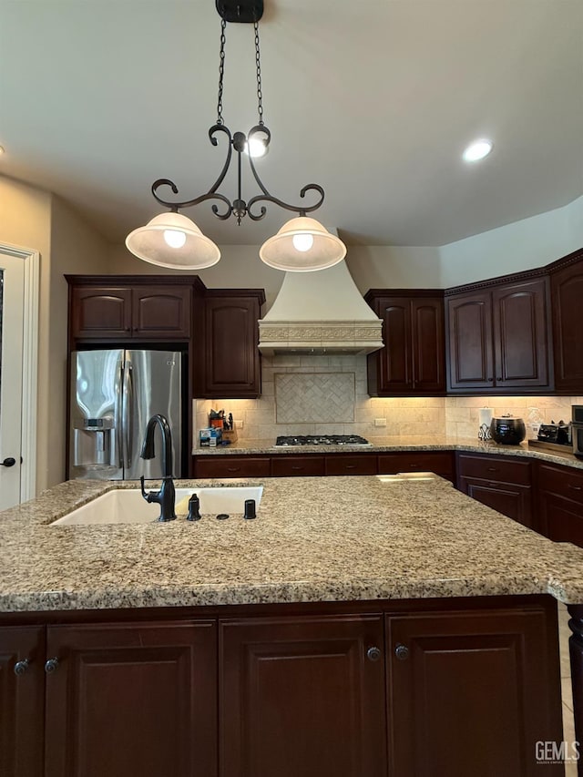 2410 Exton St, Bakersfield, CA 93311 - kitchen with appliances with stainless steel finishes, custom range hood, an island with sink, and dark brown cabinetry