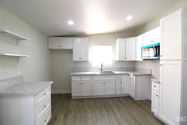 118 W 20th Ave, Delano, CA 93215 - kitchen with stainless steel microwave, a sink, recessed lighting, open shelves, and white cabinetry