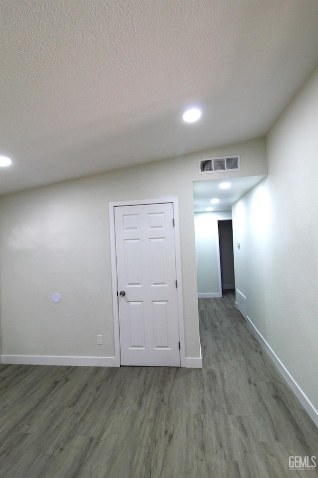 118 W 20th Ave, Delano, CA 93215 - spare room with wood finished floors, baseboards, a textured ceiling, and recessed lighting