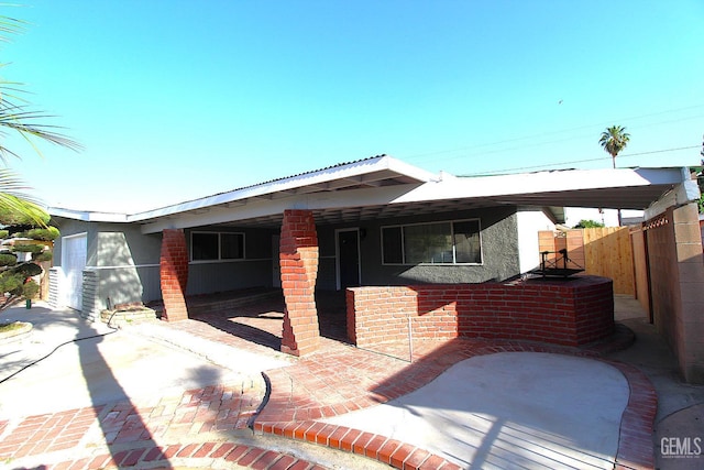 118 W 20th Ave, Delano, CA 93215 - view of front of house with a patio area and stucco siding