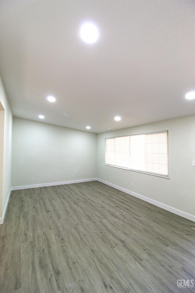 118 W 20th Ave, Delano, CA 93215 - spare room featuring recessed lighting, wood finished floors, baseboards, and a textured ceiling