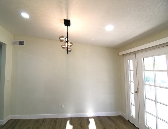 118 W 20th Ave, Delano, CA 93215 - unfurnished dining area featuring dark wood-style floors, baseboards, a chandelier, recessed lighting, and a textured ceiling