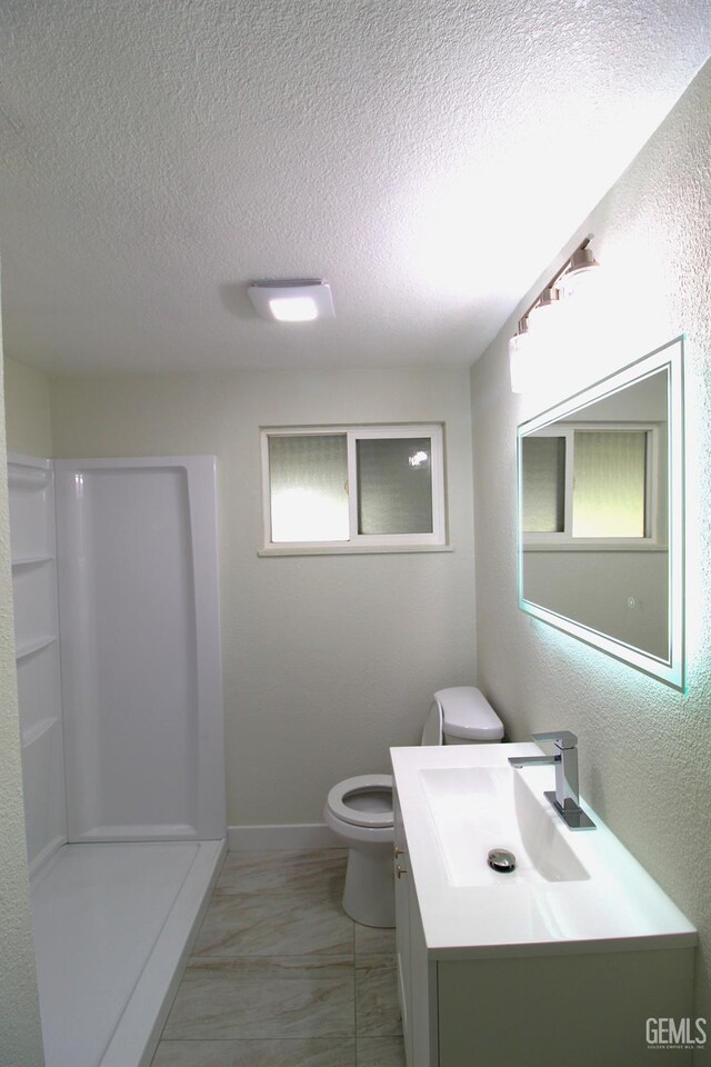 118 W 20th Ave, Delano, CA 93215 - full bathroom with a textured ceiling, toilet, vanity, a shower, and marble look tiles