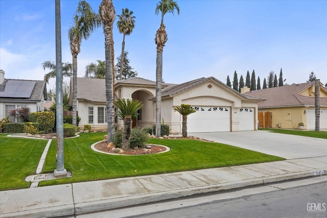 view of front of home featuring a garage and a front lawn