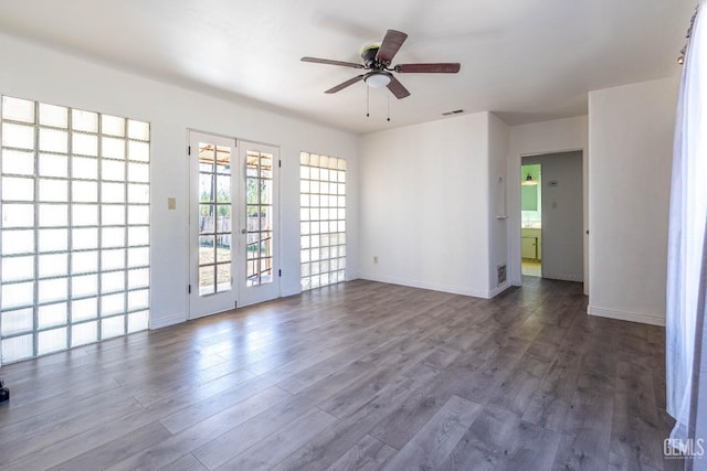 spare room featuring ceiling fan, dark wood-type flooring, and french doors