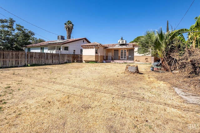 rear view of property with central AC