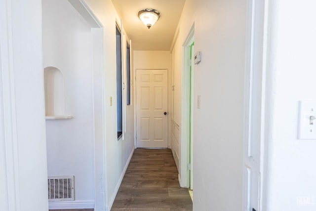 hallway with dark hardwood / wood-style flooring