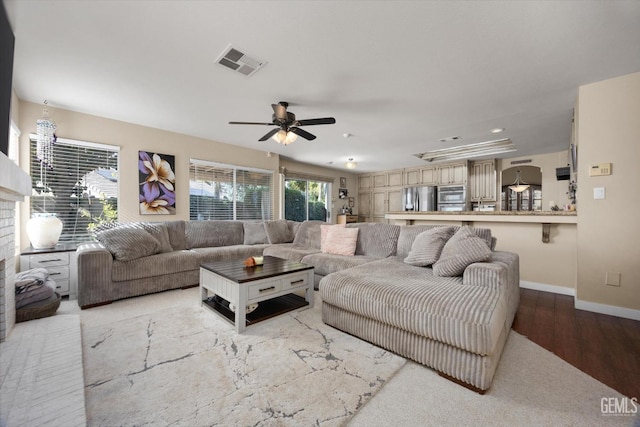 living room with ceiling fan and wood-type flooring