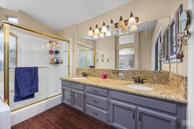 bathroom featuring vanity, lofted ceiling, and an enclosed shower