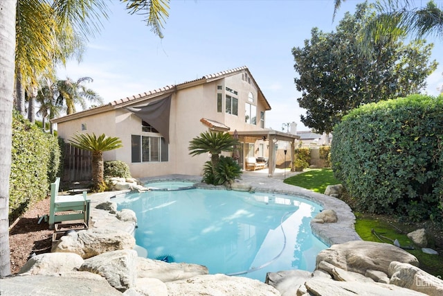 view of pool featuring a jacuzzi and a patio area