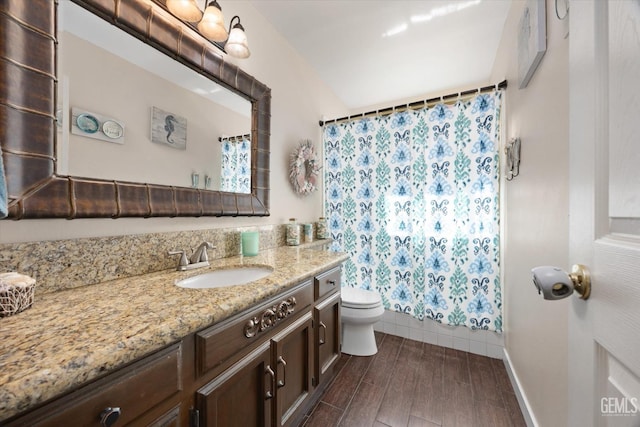 bathroom with vanity, toilet, curtained shower, and hardwood / wood-style floors