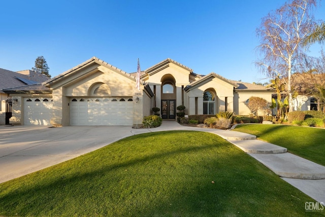 view of front of home featuring a garage, french doors, and a front lawn