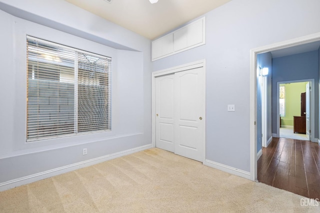 unfurnished bedroom featuring carpet floors and a closet