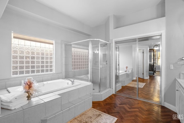 bathroom featuring parquet floors and plus walk in shower