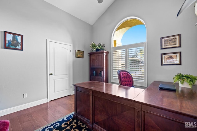 office space with ceiling fan, dark hardwood / wood-style flooring, and high vaulted ceiling