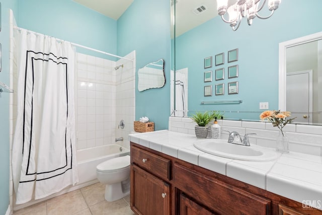 full bathroom with tile patterned floors, toilet, an inviting chandelier, vanity, and shower / bath combo