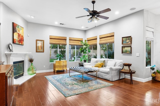 living room with dark hardwood / wood-style floors and ceiling fan