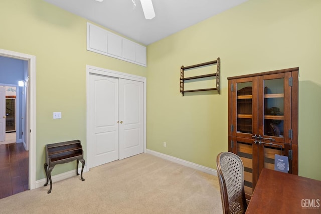 office featuring ceiling fan and light carpet