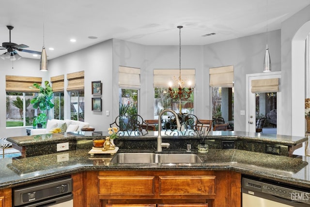 kitchen featuring stainless steel dishwasher, plenty of natural light, decorative light fixtures, and sink