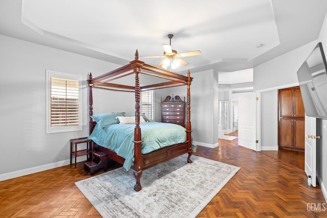 bedroom featuring ensuite bath, parquet flooring, and ceiling fan