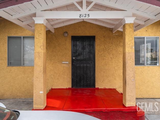 doorway to property with stucco siding