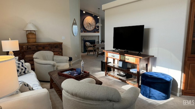 carpeted living room with a tiled fireplace and built in features