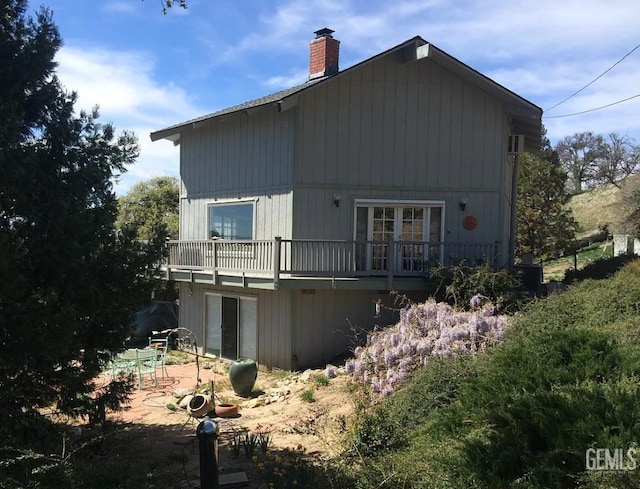 24551 Pueblo Ct, Tehachapi, CA 93561 - back of property with a chimney, a patio area, and a deck