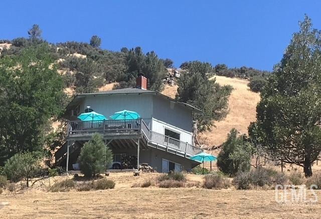 24551 Pueblo Ct, Tehachapi, CA 93561 - back of property featuring a deck and a chimney