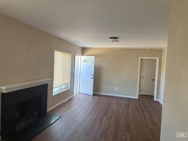 3820 Apache Ave, Bakersfield, CA 93309 - unfurnished living room with dark wood-style flooring and a tiled fireplace