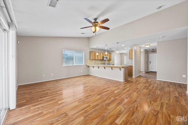 11602 Trabancos Dr, Bakersfield, CA 93311 - unfurnished living room with light wood finished floors, a ceiling fan, vaulted ceiling, and recessed lighting