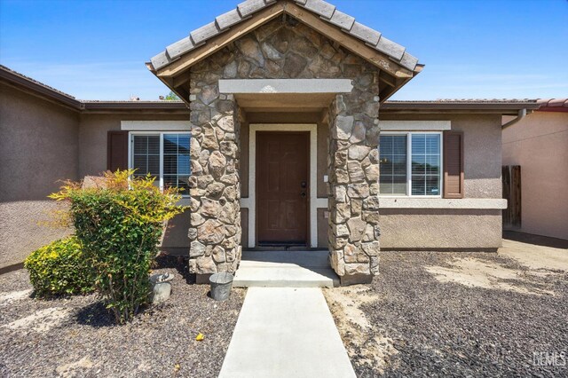 11602 Trabancos Dr, Bakersfield, CA 93311 - property entrance featuring stone siding and stucco siding