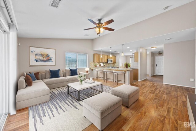 11602 Trabancos Dr, Bakersfield, CA 93311 - living area with light wood-style flooring, ceiling fan, and lofted ceiling