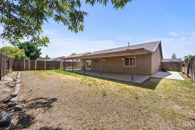 11602 Trabancos Dr, Bakersfield, CA 93311 - back of house featuring a ceiling fan, a fenced backyard, a patio area, and stucco siding