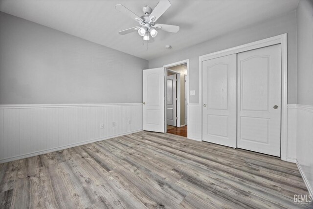 11602 Trabancos Dr, Bakersfield, CA 93311 - unfurnished bedroom with wood finished floors, a wainscoted wall, a closet, and ceiling fan
