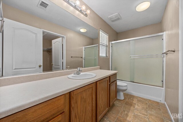 11602 Trabancos Dr, Bakersfield, CA 93311 - bathroom featuring vanity, enclosed tub / shower combo, and stone finish floors