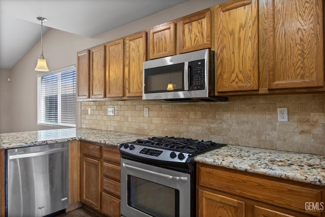 11602 Trabancos Dr, Bakersfield, CA 93311 - kitchen featuring appliances with stainless steel finishes, vaulted ceiling, brown cabinetry, backsplash, and a peninsula