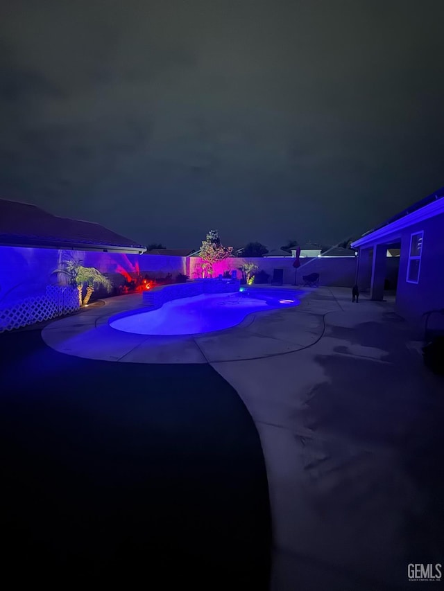 9311 Caliente Creek Ct, Bakersfield, CA 93311 - pool at night with a patio and an outdoor pool