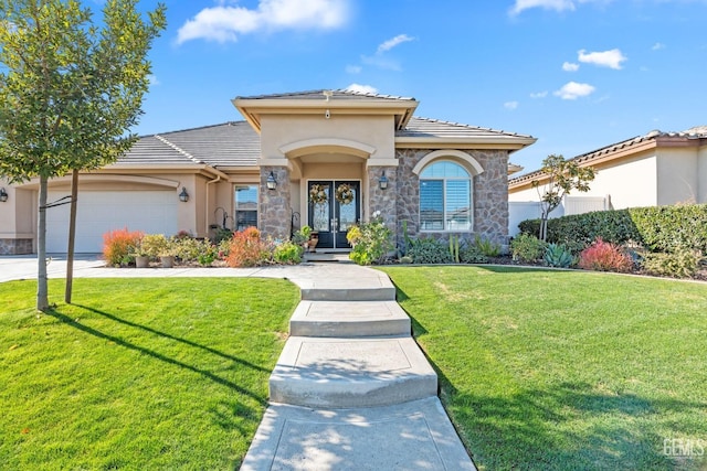 view of front of home with a garage and a front lawn