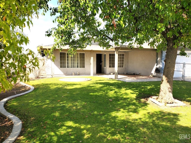 4204 Tyndall Ave, Bakersfield, CA 93313 - back of property featuring stucco siding and a patio area