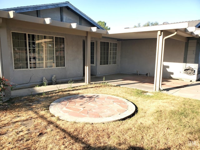4204 Tyndall Ave, Bakersfield, CA 93313 - rear view of house with a patio, stucco siding, and a lawn