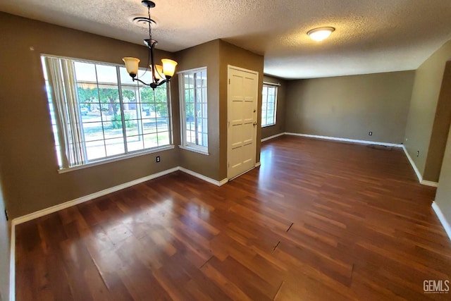 4204 Tyndall Ave, Bakersfield, CA 93313 - spare room with a textured ceiling, dark wood-style flooring, and a chandelier